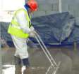 Installer dappling the liquid screed after pumping to achieve the final finish